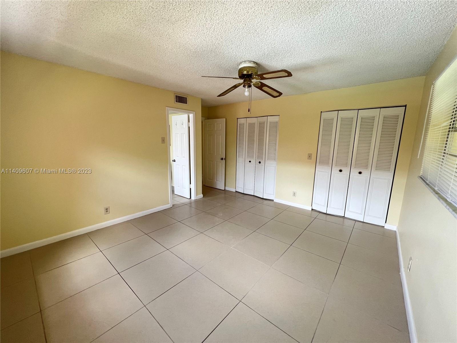 22615 Southwest 66th Avenue, Unit 216 Boca Raton, FL 33428 - Photo 17 of 23 a view of a room with a walk in closet and wooden floor