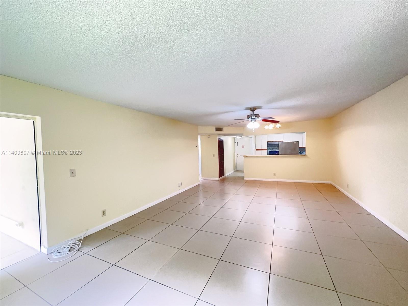 22615 Southwest 66th Avenue, Unit 216 Boca Raton, FL 33428 - Photo 3 of 23 a view of a kitchen with a sink and a refrigerator
