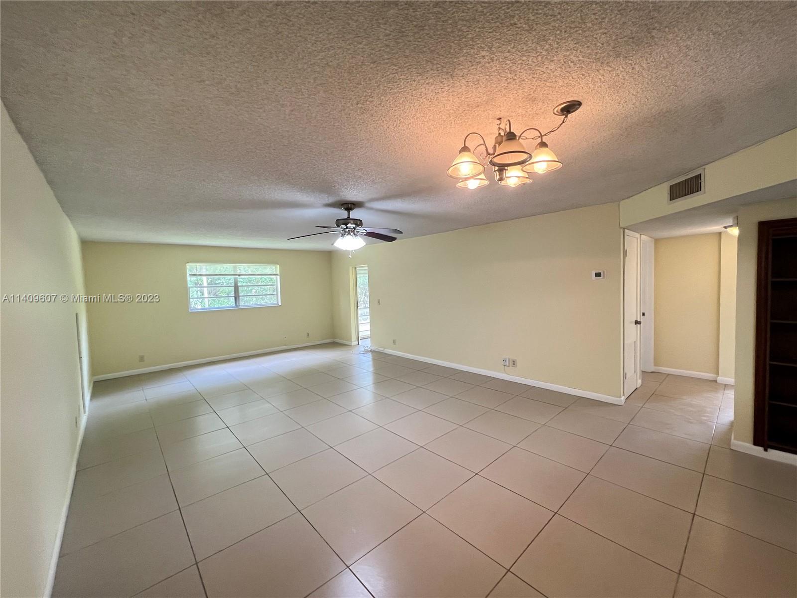 22615 Southwest 66th Avenue, Unit 216 Boca Raton, FL 33428 - Photo 4 of 23 a view of empty room with a ceiling fan