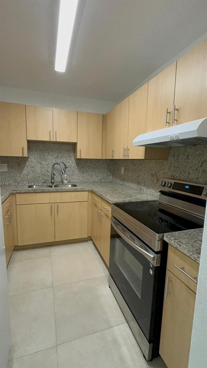 1885 West 56th Street, Unit 112 Hialeah, FL 33012 - Photo 2 of 11 a kitchen with a cabinets and white appliances
