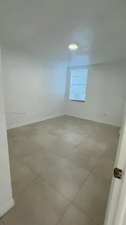 an empty room with windows and entrance