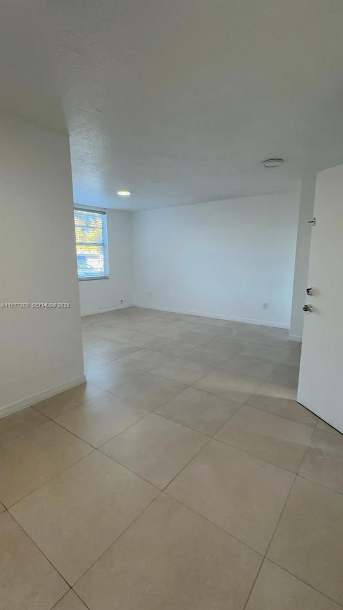 1885 West 56th Street, Unit 112 Hialeah, FL 33012 - Photo 4 of 11 an empty room with windows and entrance