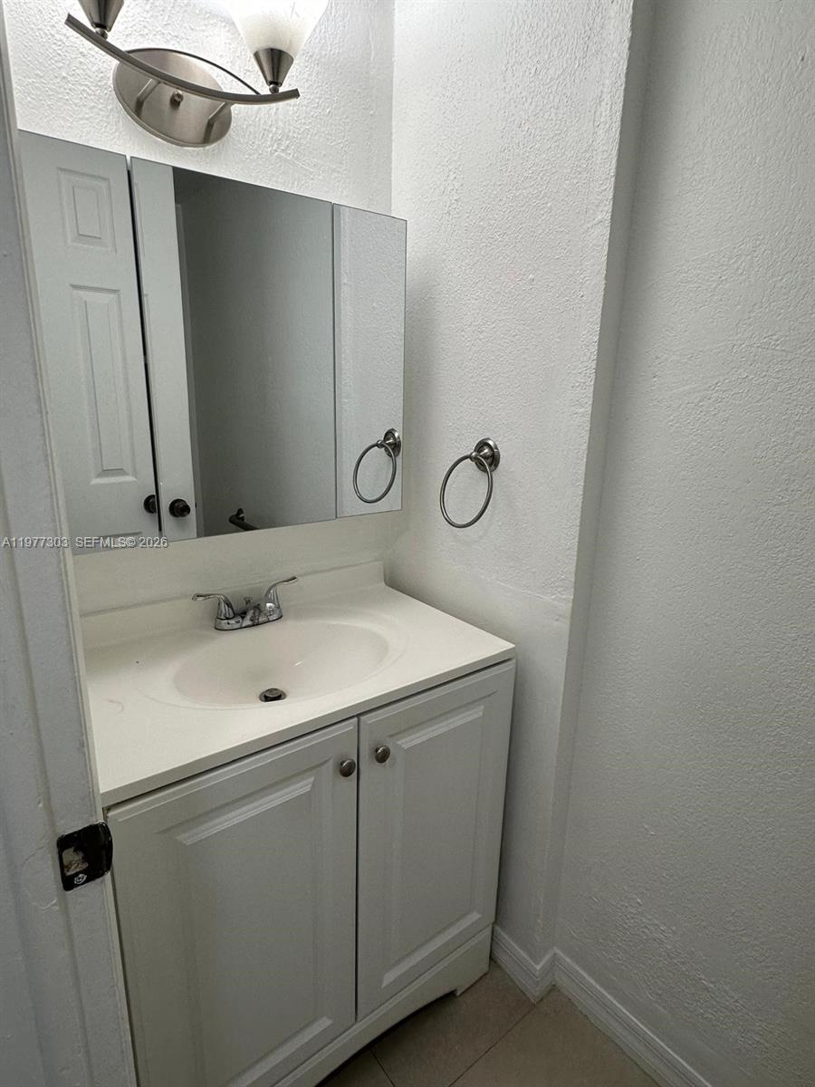 1885 West 56th Street, Unit 112 Hialeah, FL 33012 - Photo 7 of 11 a bathroom with a sink and a mirror