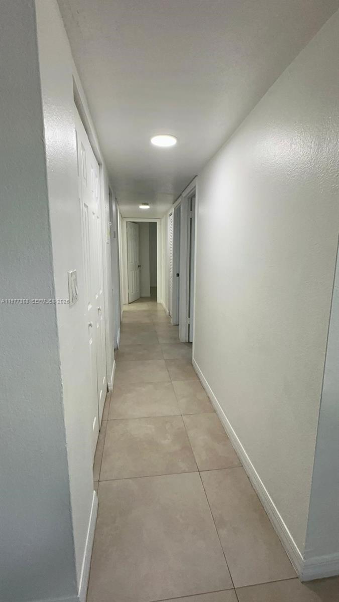 1885 West 56th Street, Unit 112 Hialeah, FL 33012 - Photo 8 of 11 a view of hallway with shower