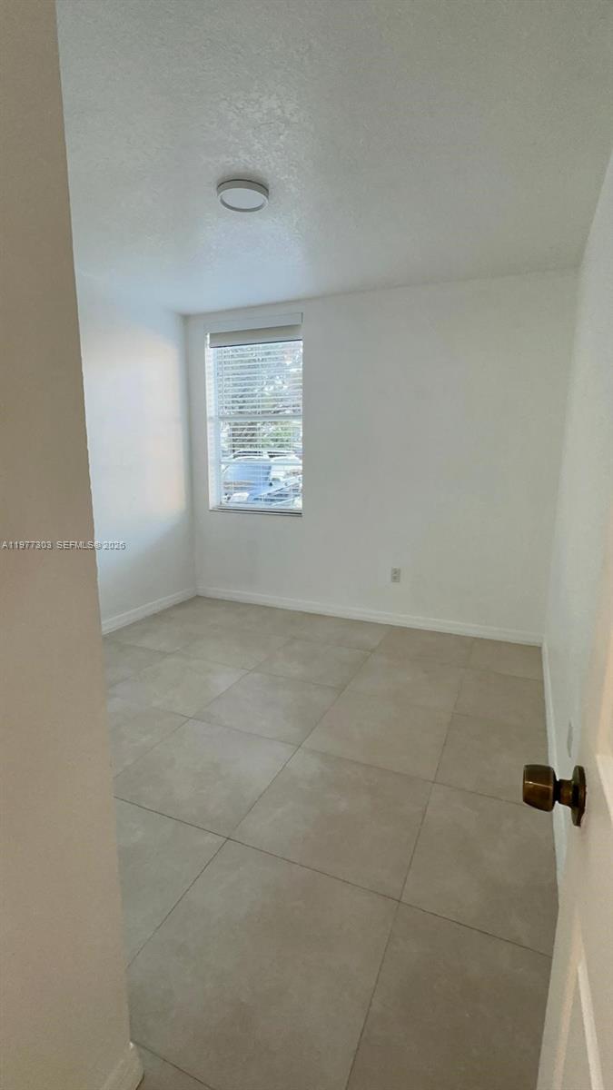 1885 West 56th Street, Unit 112 Hialeah, FL 33012 - Photo 9 of 11 a view of an empty room with a window