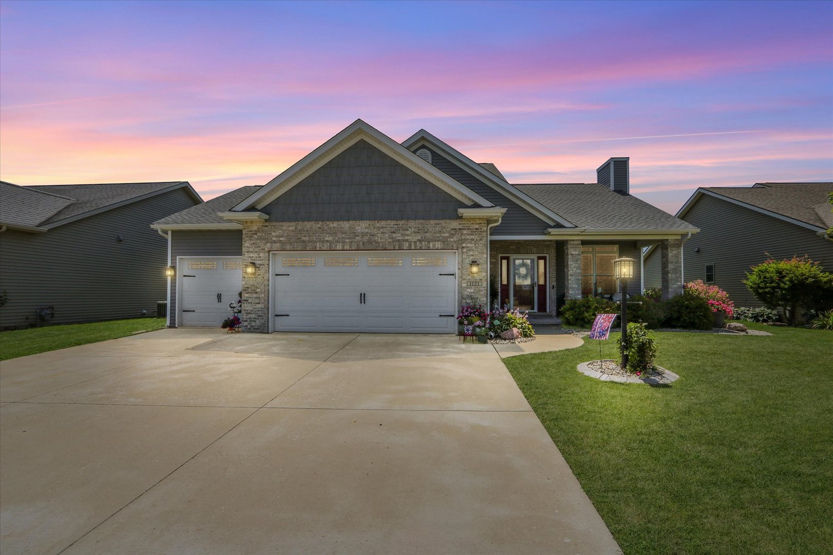1121 Declaration Drive Savoy, IL 61874 - Photo 3 of 8 a front view of a house with a garden and yard