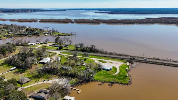 an aerial view of a houses with a lake view