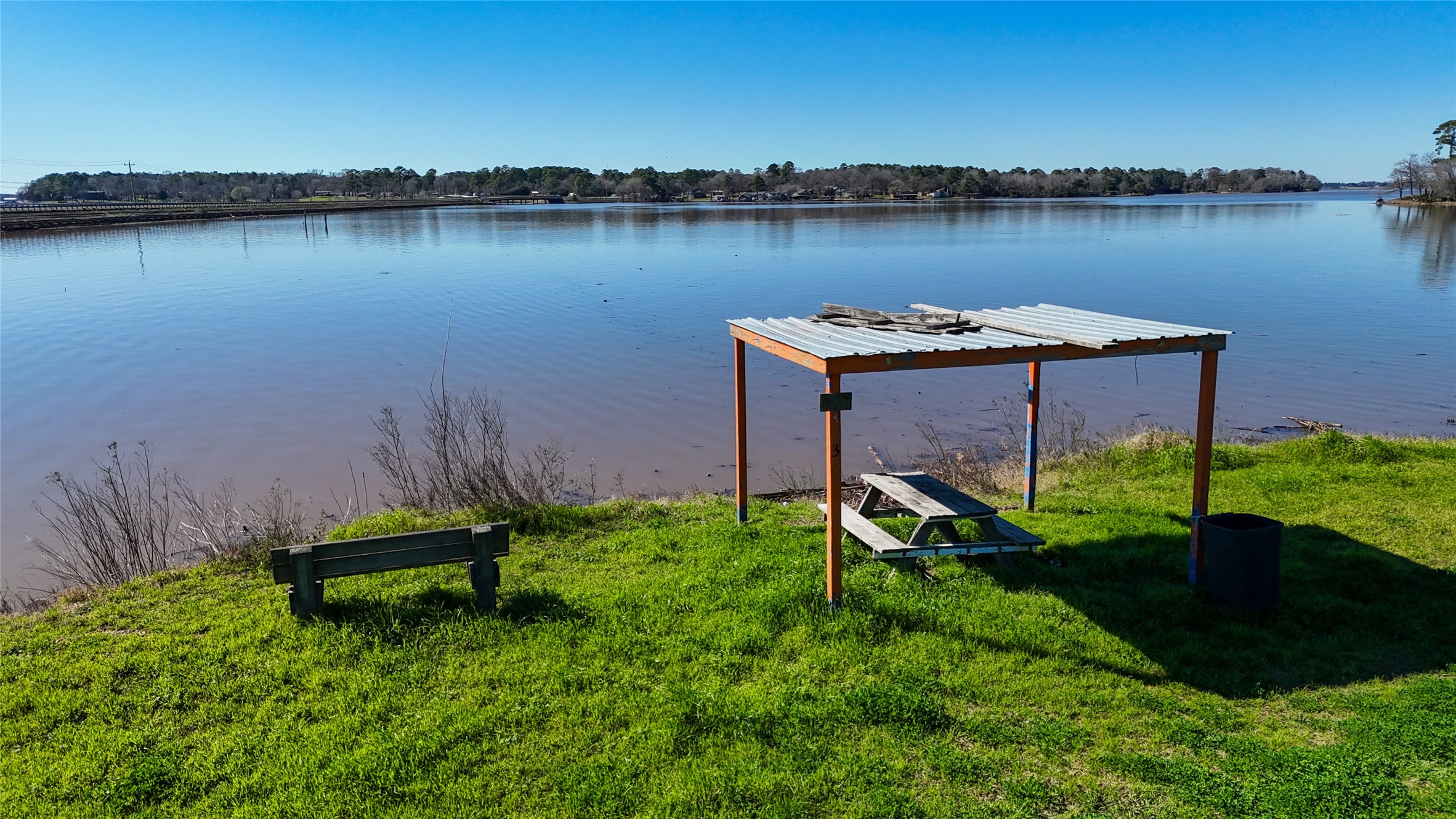 224 Steinback Avenue Trinity, TX 75862 - Photo 2 of 23 a garden with wooden fence and lake view