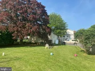 a roof deck with table and chairs and wooden floor