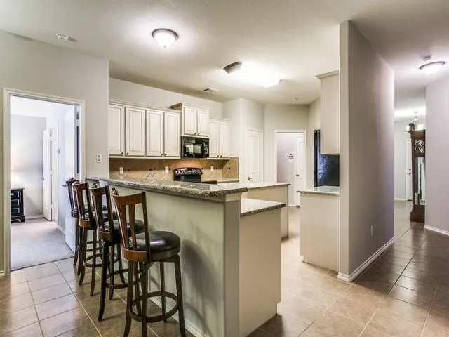 a large kitchen with granite countertop lots of counter top space