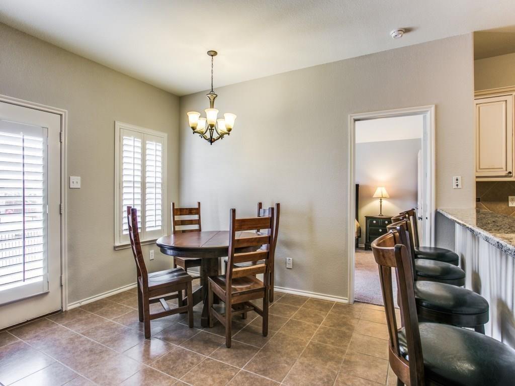 1097 Luton Drive Prosper, TX 75078 - Photo 13 of 25 a view of a dining room with furniture and a chandelier