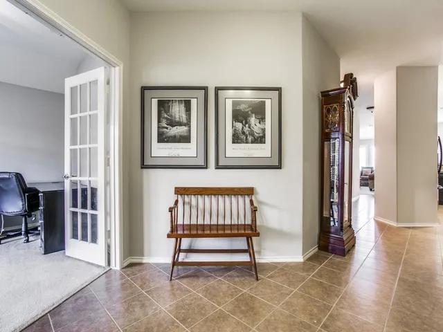 a view of a dining room with furniture and a chandelier