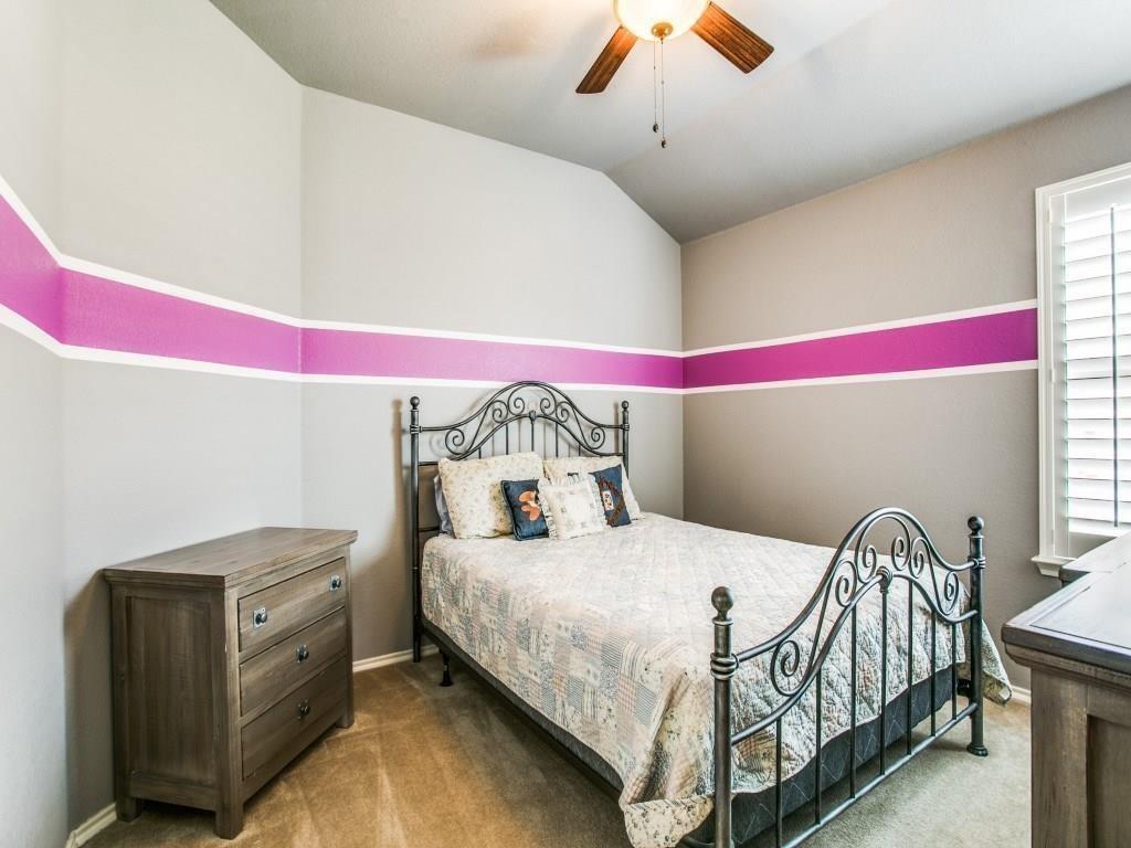1097 Luton Drive Prosper, TX 75078 - Photo 21 of 25 a bedroom with a bed and dresser