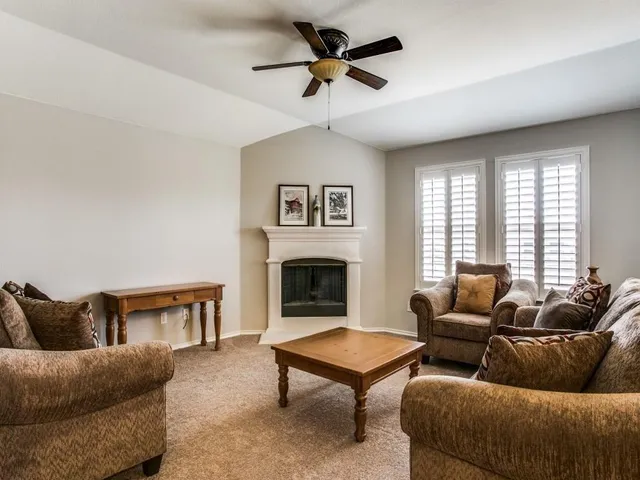 a living room with furniture a rug and a fireplace