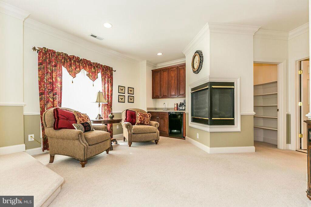 604 Clear Spring Road Great Falls, VA 22066 - Photo 15 of 28 a living room with furniture flat screen tv and a fireplace