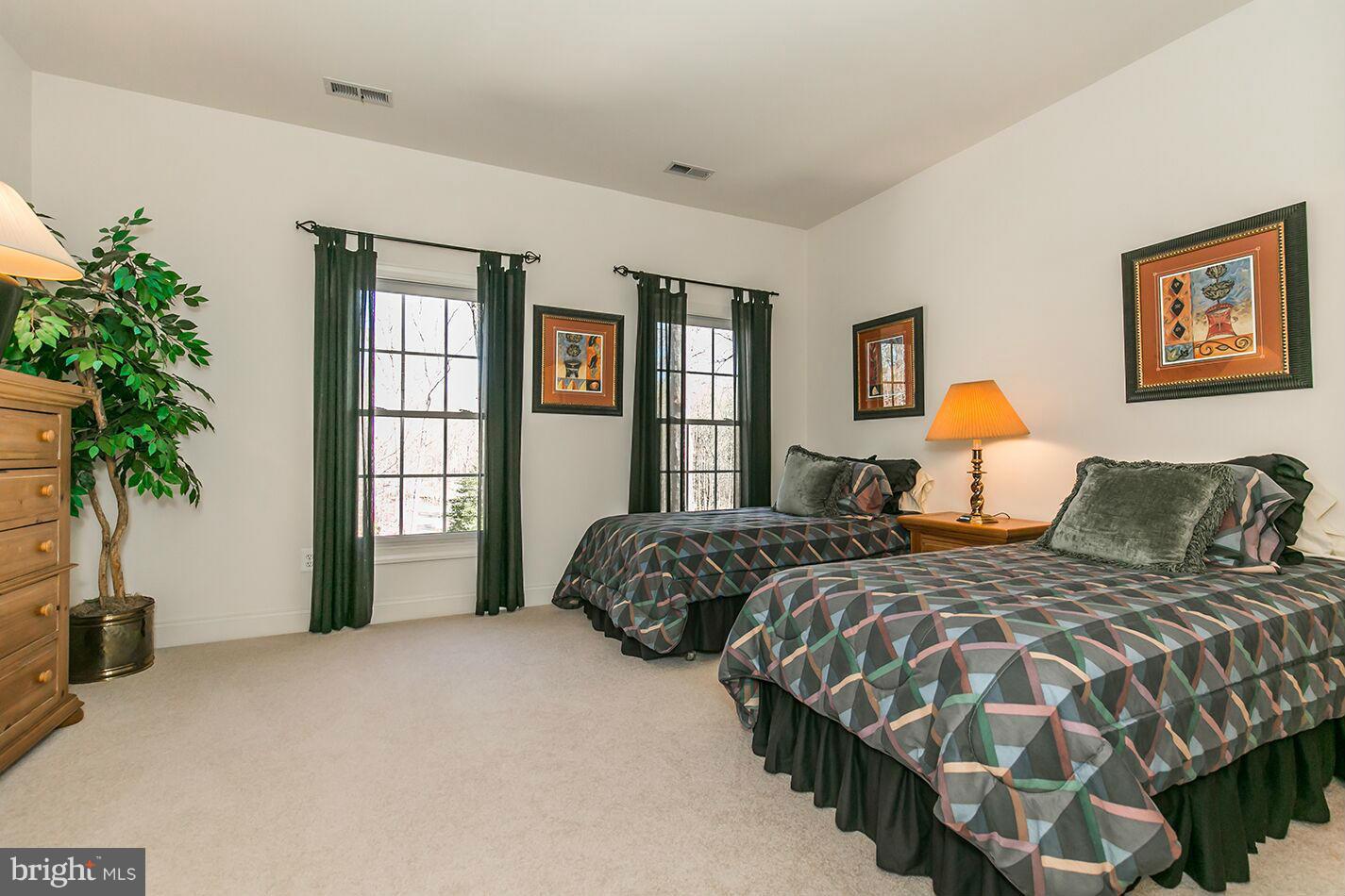 604 Clear Spring Road Great Falls, VA 22066 - Photo 19 of 28 a bedroom with two beds and potted plant with window