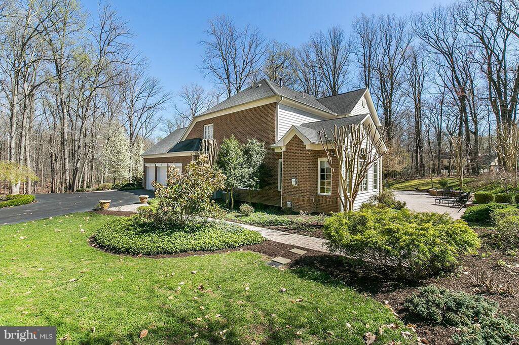 604 Clear Spring Road Great Falls, VA 22066 - Photo 24 of 28 a front view of a house with garden