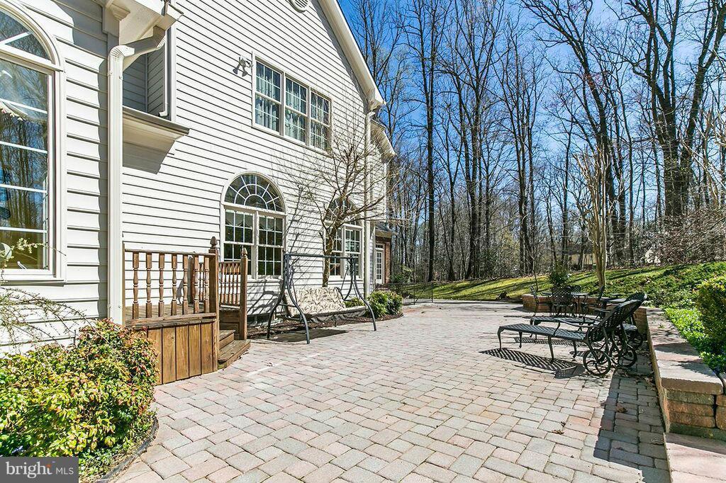604 Clear Spring Road Great Falls, VA 22066 - Photo 27 of 28 a view of a patio with a table and chairs and potted plants