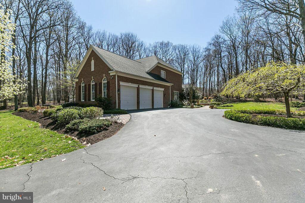 604 Clear Spring Road Great Falls, VA 22066 - Photo 28 of 28 a front view of a house with a yard and trees