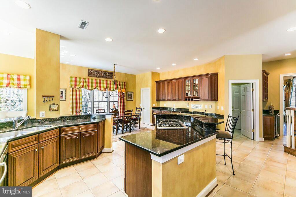 604 Clear Spring Road Great Falls, VA 22066 - Photo 5 of 28 a kitchen with stainless steel appliances granite countertop a sink and cabinets