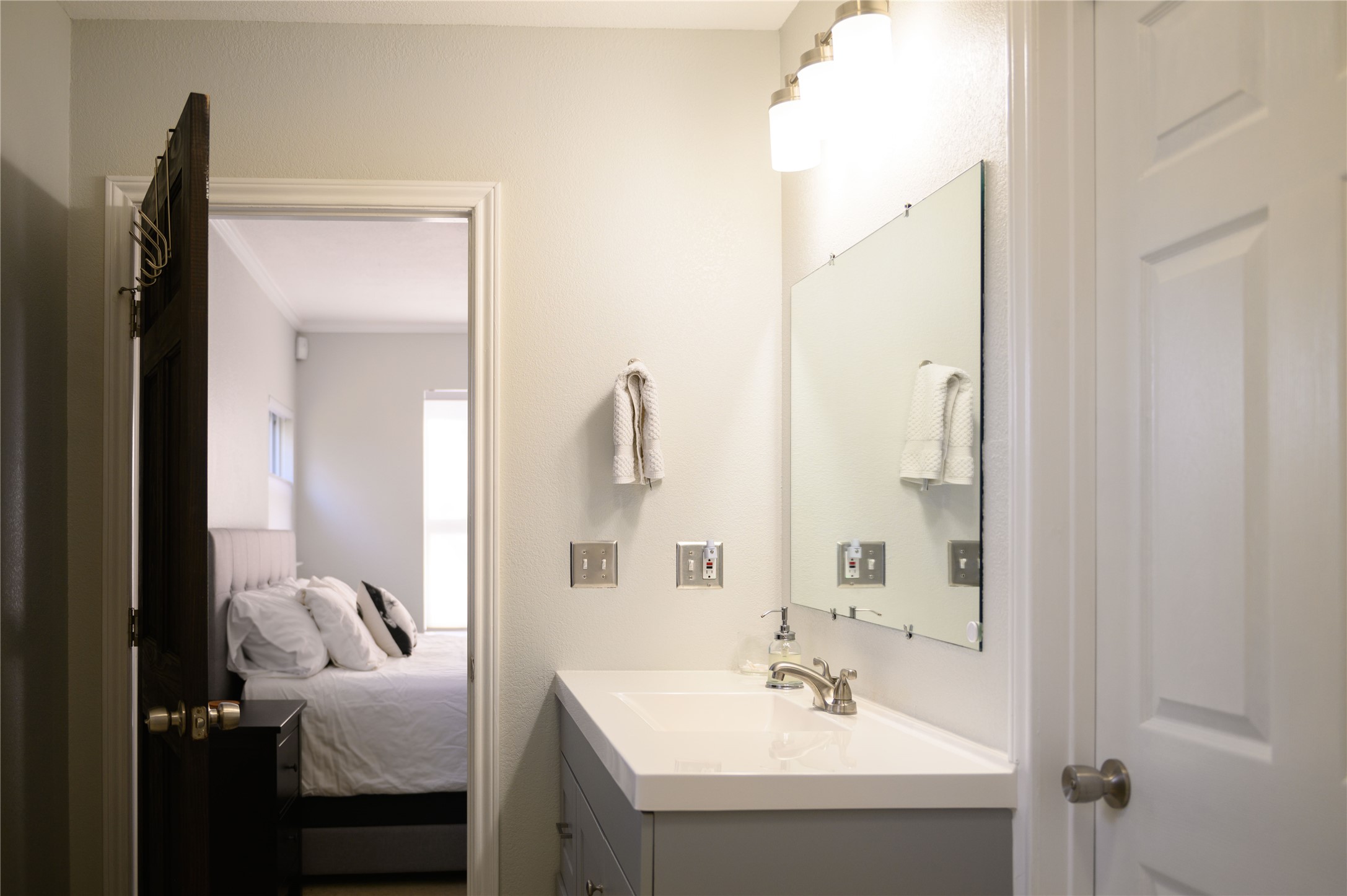 4902 Pecan Springs Road Austin, TX 78723 - Photo 39 of 40 a bathroom with a sink vanity and a mirror