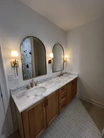 a bathroom with a double vanity sink and a mirror