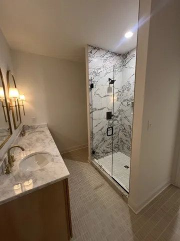 a view of a bathroom with a sink and mirror