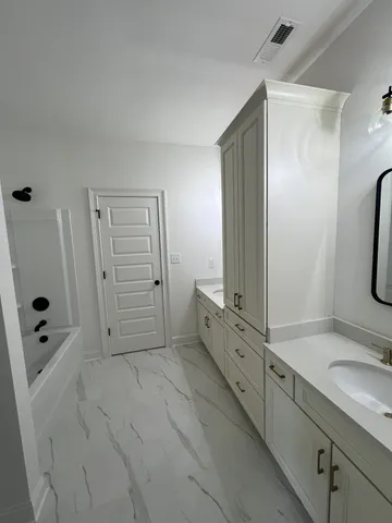 a bathroom with a double vanity sink a mirror and shower