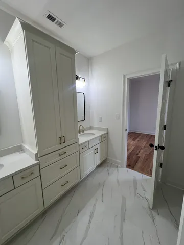 a bathroom with a sink a mirror and a shower