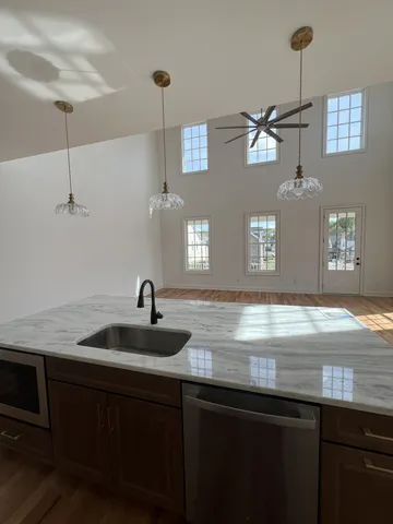 a kitchen with a sink and chandelier