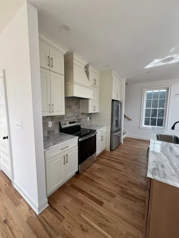 a kitchen with stainless steel appliances granite countertop a stove and a refrigerator