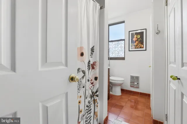 a bathroom with a toilet and a shower