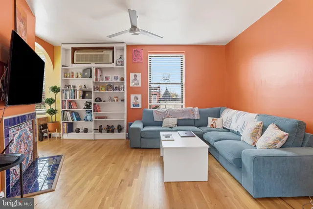 a living room with fireplace furniture and a flat screen tv