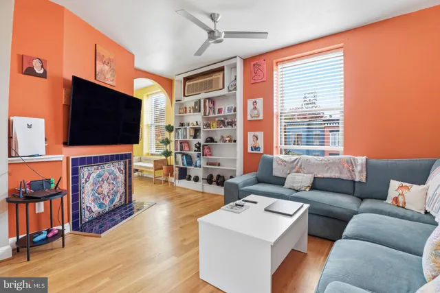 a living room with fireplace furniture and a flat screen tv