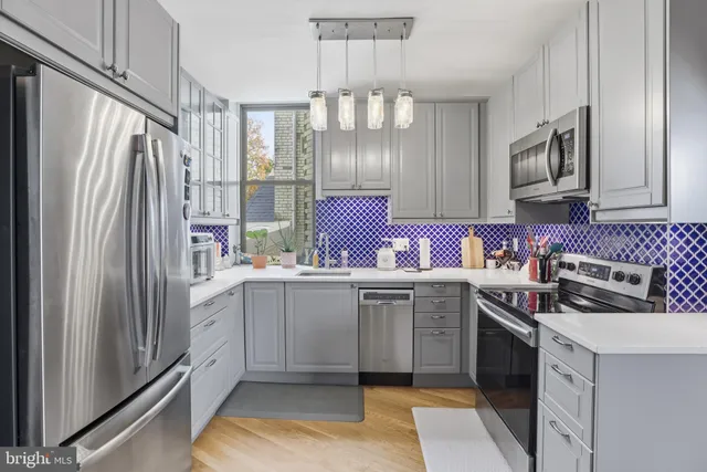a kitchen with stainless steel appliances a sink cabinets and a counter top space