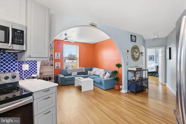 a living room with fireplace furniture and a wooden floor