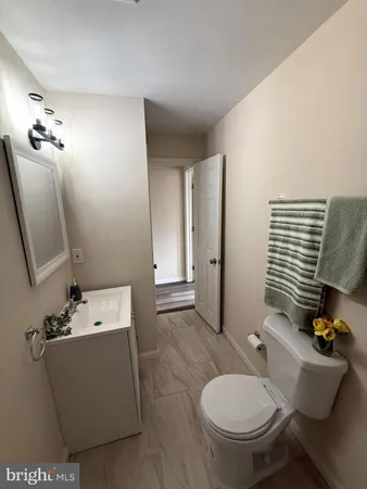 a bathroom with a toilet sink and mirror