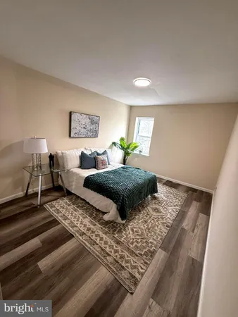 a bedroom with a large bed and a rug