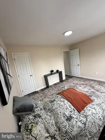 a bedroom with a bed and a couch