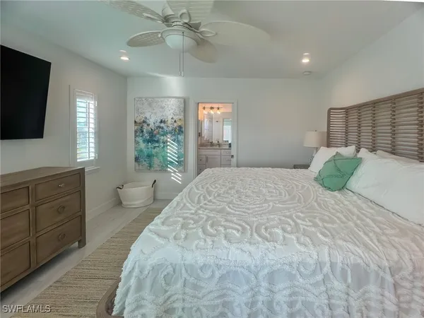 a bedroom with a bed and a flat screen tv in it