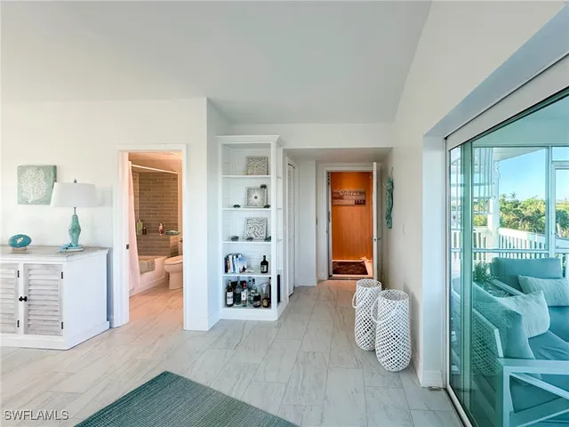 a living room with furniture large window and a flat screen tv