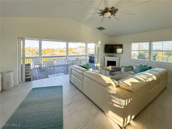a bedroom with a bed and a flat tv screen on dresser