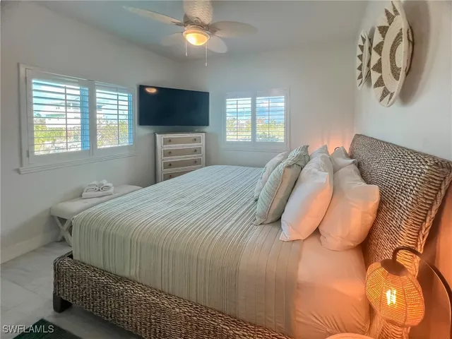 a bedroom with two beds and a flat screen tv