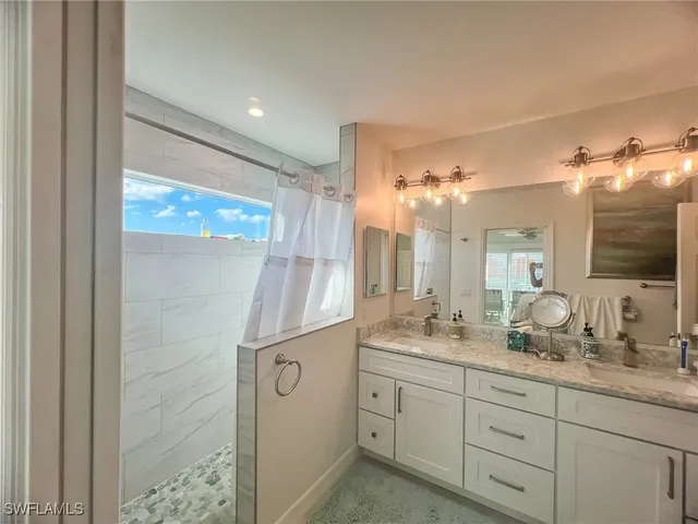 a bathroom with a double vanity sink and a mirror