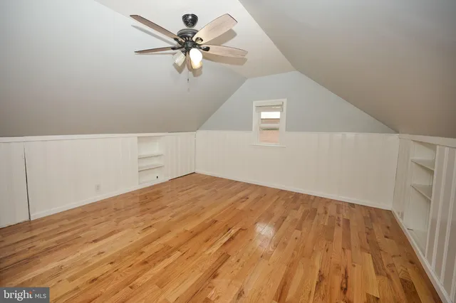 a view of a big room with wooden floor and a ceiling fan