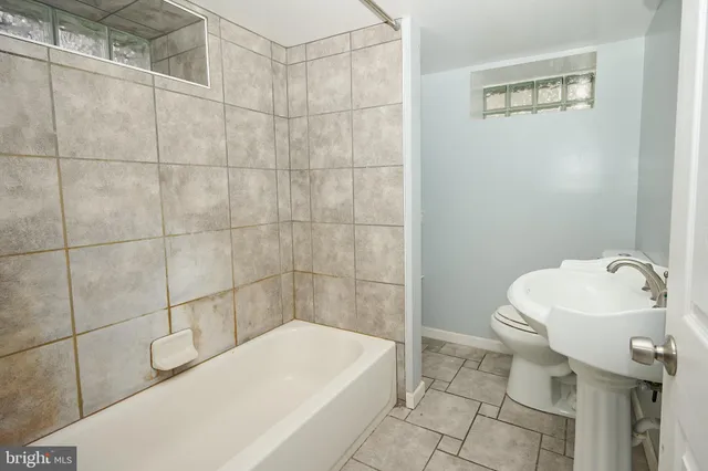 a bathroom with a sink a toilet and bathtub