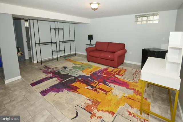 a living room with furniture rug and wooden floor