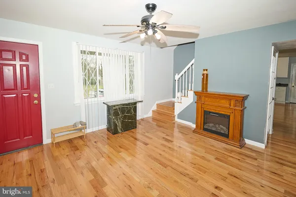 a view of livingroom with hardwood floor and a fireplace