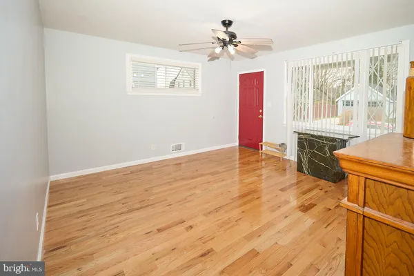 a view of a kitchen with wooden floor and stainless steel appliances