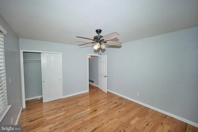 a view of a room with wooden floor